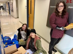 Student boxing donations for the Bridge Book book drive