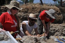 photo of three adults at excavation site
