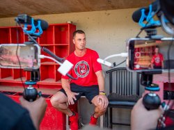 Cameras focus on New Jersey Jackals pitcher Dylan Brammer as he shares his path to professional baseball with students in the Summer Journalism Workshop.