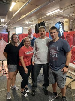 Two students and two professors standing in a row with the Montclair State football coach.