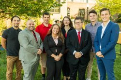 Group of eight college students dressed professionally and smiling