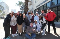 Students in a group with a professor smiling during a class trip to New Orleans