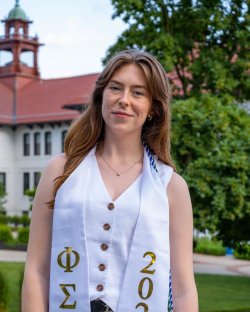 Grace poses for photo on graduation day.