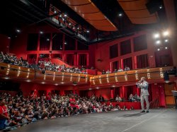EOF Opening Ceremony, man stands on stage talking to audience.