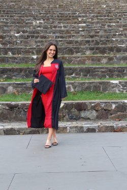 Alum Claudia Challender posing in graduation gown