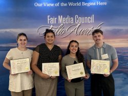 Group photo of students holding Folio Awards in front of backdrop.