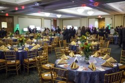 The purple tablecloths and gold napkin decor of the 2012 Annual Dinner hosted in the Main Ballroom of the Conference Center.