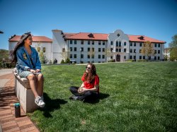 Two students sitting outside Russ hall