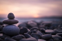 Sunset with pebbles on beach in Nice, France.