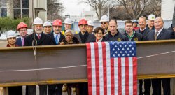 Montclair State University and Terminal Construction executives and administrators pose with the topping-off beam for the new Center for Environmental and Life Sciences.