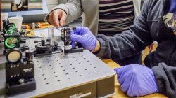 student working with gravitational wave detection equipment