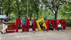 Dr Carlos Molina and 2022 IRES students group photo on sculpture