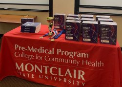 Pre Med Program table at HOSA Panel event with MCAT review materials