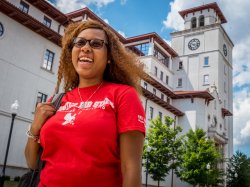 Student smiling outside of University Hall