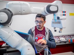 Student working on computer in robotics lab