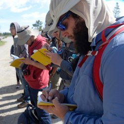 students taking notes on hike