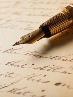 Image of a fountain pen with a manuscript.