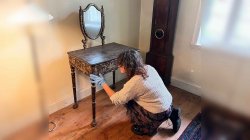 Cristina Freire examining Wyck’s lacquered Writing Desk up-close.