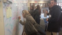 woman signing wall