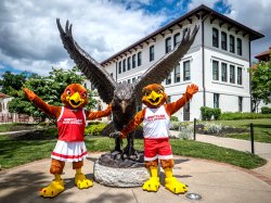 Rocky and Roxy alongside the hawk statue outside of Cole Hall