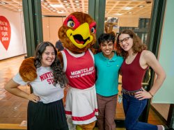 Roxy the Red Hawk hanging out with a group of students