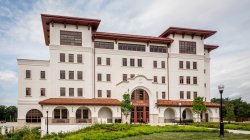 Exterior of the School of Business building with landscaping