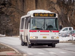 Shuttle bus on the road. Sign displaying route V/T-Village-NJT.