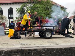 Photo of Bradford School Principal putting out an outdoor fire during University Facilities' annual Earth Day program on April 26, 2022