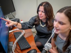 Elaine Hitchcock works with a student in her Clinical Biofeedback Laboratory.