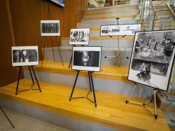 Several photos on easels arranged on teirs in school of communication and media lobby