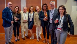 Group of donors pose for photo in hallway