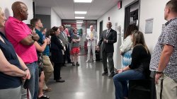 Jeff Jones in hallway with crowd