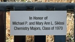 Photo of plaque on bench reading In honor of Michael P and Mary Ann L Siklosi Chemistry Majors, Class of 1970