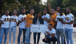 Greek students posing with large check