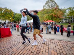 students dancing on campus