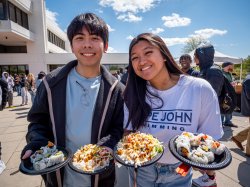 Photo of two students holding food