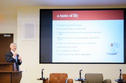 Photo of Illy executive presenting.