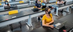 photo of female students in classroom socially distanced wearing facemasks