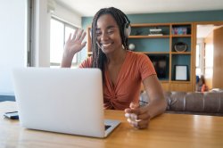 african american Woman working from home. waving to laptop