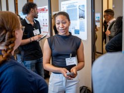 Female student presenting at symposium.