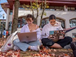 Two female students working on laptops.