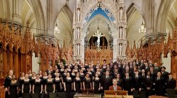 Large choir poses in a cathedral.