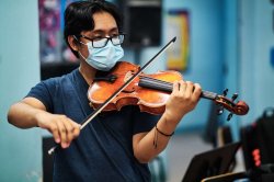 Pathways program student plays new violin