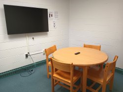 Table and chairs with monitor