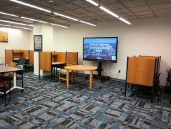 CAST study hall with monitor, desks and, chairs