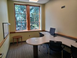 Study room with table, chair, computer, and whiteboard