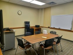 Study room with table, chairs, whiteboard and smartboard