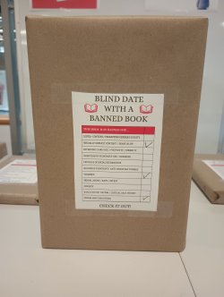 a wrapped book with a label indicating why it was banned