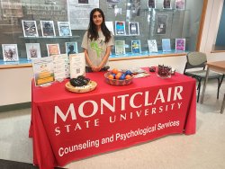 student standing at table with swag