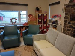 a couch and chairs in the drop-in center